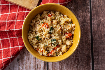 Top view of couscous salad in rustic bowl