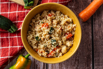 Top view of couscous salad in rustic bowl