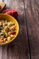 Top view of couscous salad in rustic bowl
