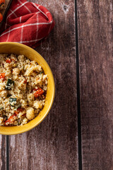 Top view of couscous salad in rustic bowl