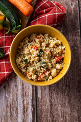 Top view of couscous salad in rustic bowl