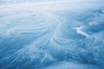 Obraz premium Ice patterns on a frozen surface. Delicate, swirling frost formations on a light-blue ice sheet