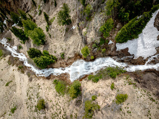 Waterfall winds through a canyon in spring