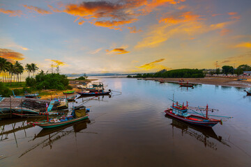Village fishing port in the morning in Thailand,Panoramic photo of fishing boats and sea in the morning,Panoramic photograph of a fishing village in the early morning in Thailand.  © banjongseal324