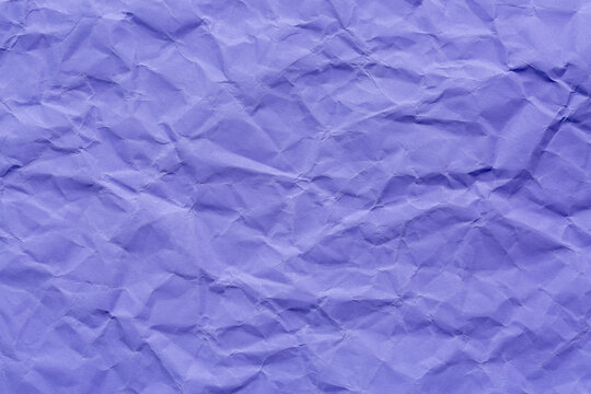 Close-up macro of crumpled purple paper background,Сrumpled paper texture purple. Texture of crumpled paper. Crumpled paper. Wrinkles paper.