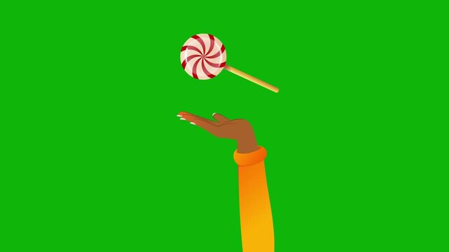 a young girl's hand with a christmas candy floating above it. a mockup for an advertisement for new year's sweets.