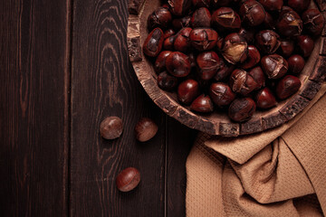 roasted chestnuts, in a wooden plate, top view, homemade, no people,