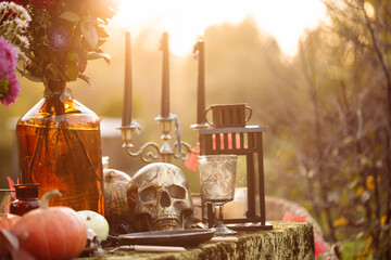 Fall themed holiday table setting arrangement for a seasonal party, glasses, pumpkins, candles,...