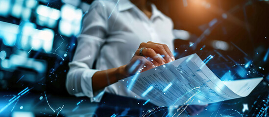 Businesswoman Reviewing Documents: A focused businesswoman, bathed in the cool blue glow of modern technology, intently reviews important documents.