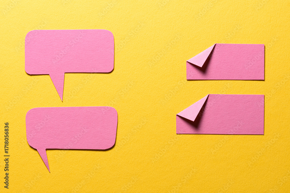 Poster pink speech bubbles and paper memo notes with folded dog-ear earmark and copy space for text on yell