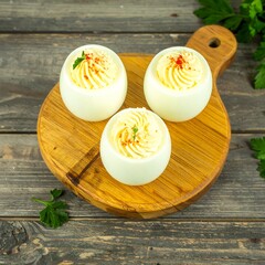 Deviled eggs on a wooden board
