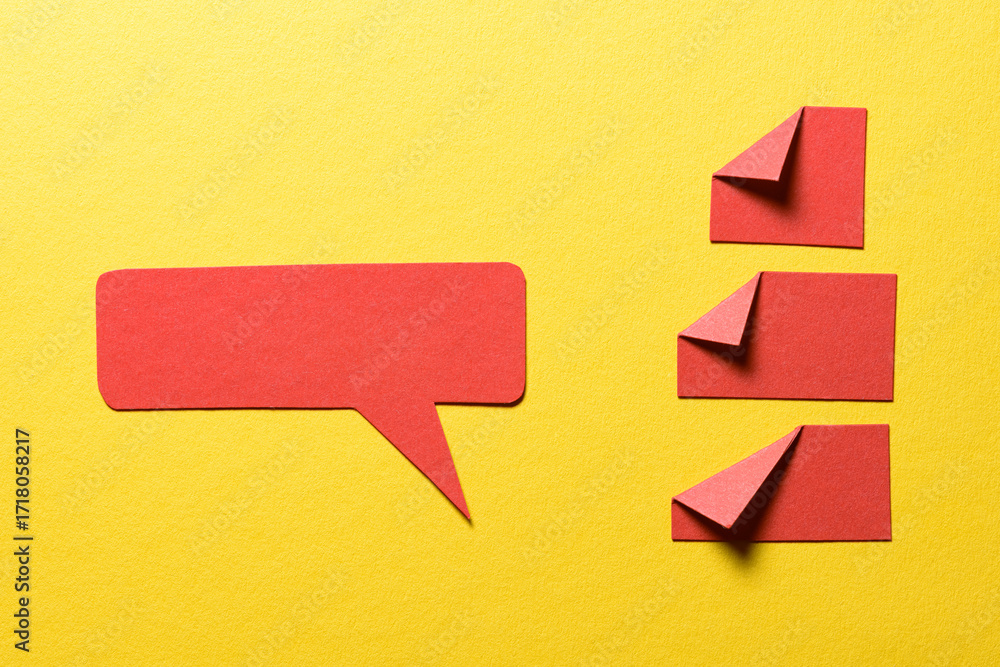 Poster red speech bubble and paper memo notes with folded dog-ear earmark and copy space for text on yellow