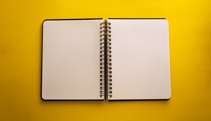 an open spiral notebook lays flat on a bright yellow background inviting creativity and ideas to flow freely onto its blank pages