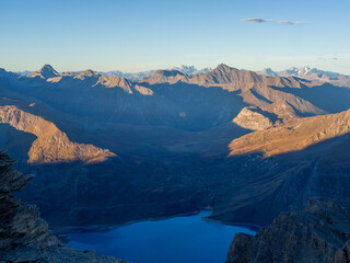 Golden Sunrise over Mont Cenis Lake in the French Alps – Scenic Mountain Landscape and Morning Light