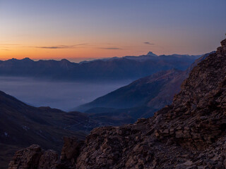 Sunrise over Mont Cenis Valley in the French Alps – Peaceful Mountain Landscape with Morning Fog and Warm Light