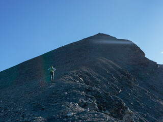 Solo Hiker Climbing a Steep Ridge Toward the Summit – Determination and Adventure in the French Alps