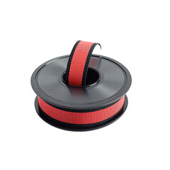 Typewriter ribbon spool isolated on a white background. Vivid Red Ribbon on a Spool: A close-up, studio shot of a vibrant red ribbon neatly rolled on a black spool