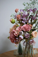 A photograph of beautiful flowers arranged in a vase, taken indoors