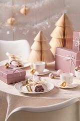 Stunning Christmas tableware surrounded by Christmas ornaments.