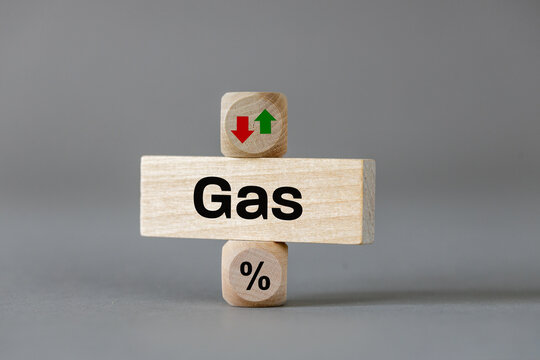 Gas prices. Wooden blocks with arrows symbolizing the increase or decrease in costs. The symbol of a percentage. Business and economic concept. close up