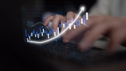 A close-up view of hands typing on a keyboard, enhanced by a digital graph that symbolizes financial growth and data analytics in a contemporary workspace setting. Copula