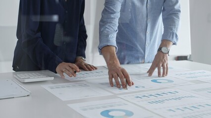 Professional business team analyzing financial reports, sharing insights and planning strategic decisions in modern office