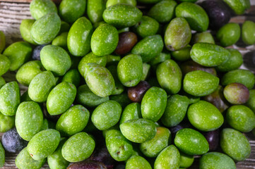 Green Cypriot Olives Lying on Wooden Table