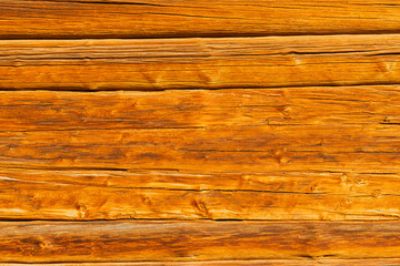 background in the form of a wall made of old wood. wood texture. wall made of old logs. natural wood background. aged logs. High quality photo
