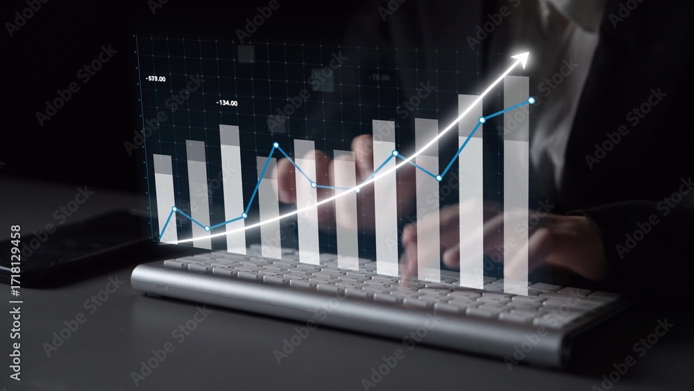 Poster A business professional engages in financial analysis, with hands on a keyboard and a digital graph displaying upward trends in a modern office setting. Copula