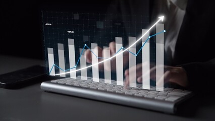 A business professional engages in financial analysis, with hands on a keyboard and a digital graph displaying upward trends in a modern office setting. Copula