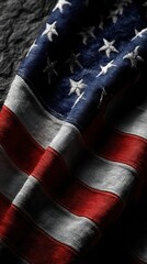 Old worn American flag draped over textured surface highlighting patriotic colors and stars