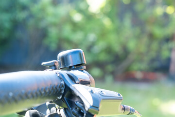 Close-up of bell on bicycle handlebar, detail of bike accessory