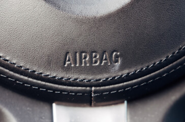 Close-up of airbag in steering wheel of modern car, detail of advanced safety technology