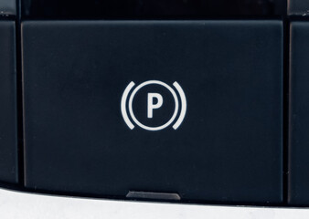 Close-up of electronic parking brake button in car with “P” symbol, detail of modern vehicle technology