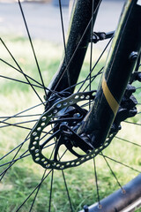 Close-up of quick release on front wheel with disc brake, detailed shot of modern bicycle technology