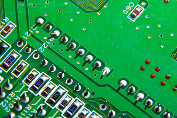 Green electronic printed circuit board with many tracks and electronic components