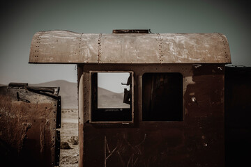 An abandoned locomotive cemetery in Uyuni. Old, rusty, forgotten trains in Bolivia. Sunny day. Blue sky.