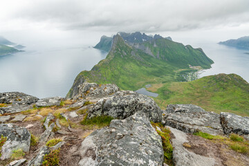 View from Barden peak towards Fjordgard, Segla and Kongen group. The two fjords are Mefjorden and Ornfjorden. Hiking destination during cloudy summer day on Senja island. Arctic island in Norway.