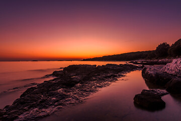 Beautifull sunset at the beach with purple sky 