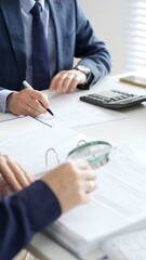 Professional male accountant calculating taxes and analyzing financial data in office setting. Audit and taxes in business