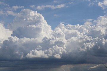Celestial Cumulus: Majestic cumulus clouds dominate the vibrant blue canvas of the sky, presenting a dramatic spectacle of nature's artistry.