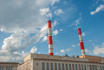 Factory with Red and White Chimneys in Moscow Against Blue Sky