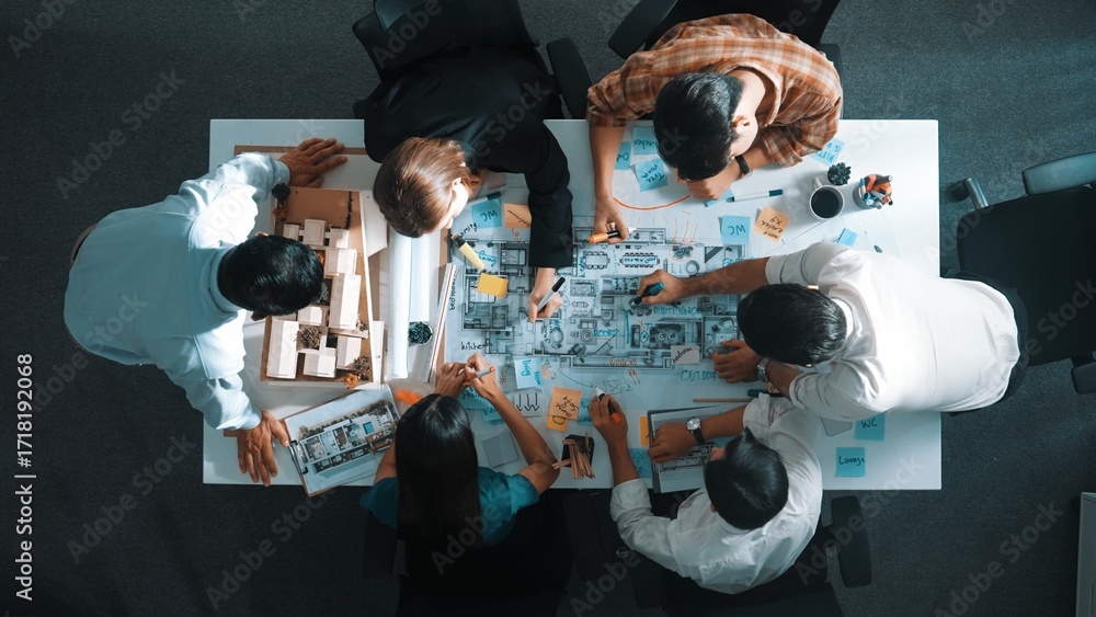 Poster Top aerial view of project manager or civil engineer writing at blueprint and planning building design. Aerial view of architect working together at meeting table with document placed. Alimentation.