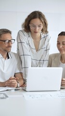 Fototapeta premium Business people team collaborating on a project, analyzing data on a laptop during a productive office meeting, fostering teamwork and strategic planning