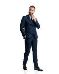 Fototapeta premium thoughtful mature businessman in navy blue suit touching chin and thinking