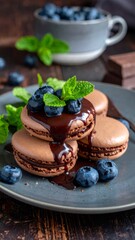 Chocolate macarons with fresh blueberries and mint topping