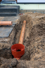 Close-Up of Underground Sewer Pipe Installation in Residential Construction Site.