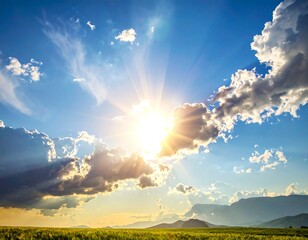 Bright sun breaking through clouds over a field