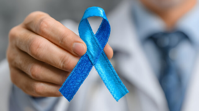 doctor hand holding blue ribbon in loop shape on white background, prostate cancer symbol, november, prostate cancer awareness month, male oncology, medicine, health