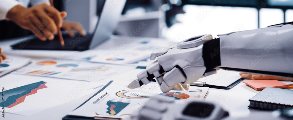 Poster a futuristic office scene showcasing a robot and a human working together on business charts, highli